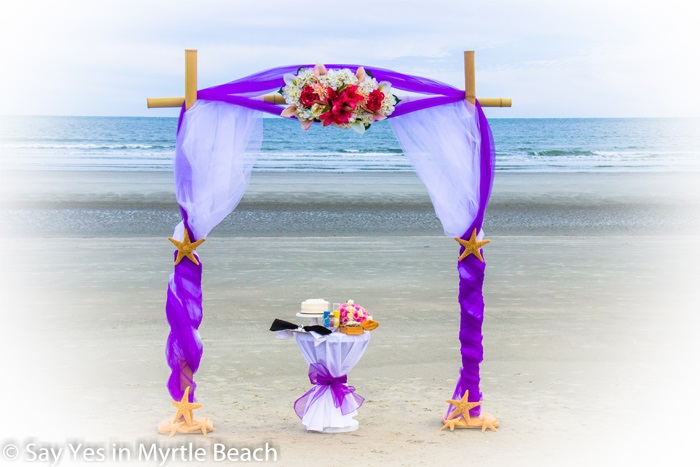 Purple and white tulle wrapped arbor